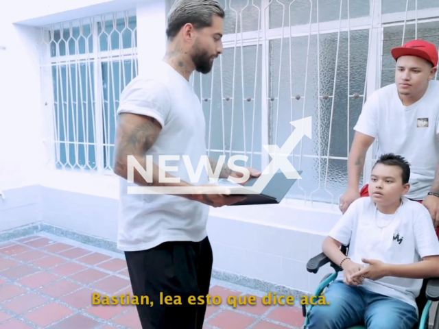 Picture shows singer Maluma and Bastian Matias Madrid, (left) a boy fighting bone cancer, and an unidentified man, undated. The singer gave the boy a house because his family don't have a place to live, in September, 2022. Note: This picture is a screenshot from the video (@maluma/Newsflash).