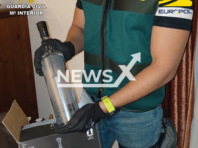 Police officer  holds a bottle during operation Whitewall, in Malaga, Spain, undated.    Police dismantled an international criminal organization that operated in Spain dedicated to money laundering using a luxury brand of vodka they created.
Note: Police photo. (Newsflash)