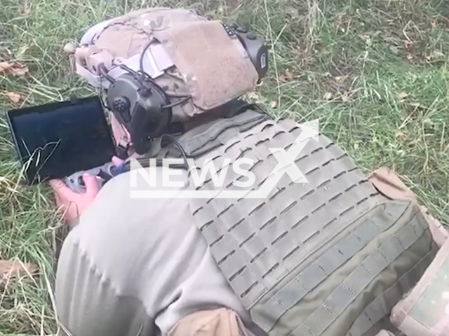 Ukrainian soldier works with remote screen of an unmanned aerial vehicle (UAV) on ground in Kharkiv region, Ukraine in undated photo. As a result of combat work of Border guards, together with units of the Armed Forces, Russian armored vehicles and personnel positions were damaged. Note: Picture is a screenshot from a video (@dpsu.gov.ua/Newsflash)