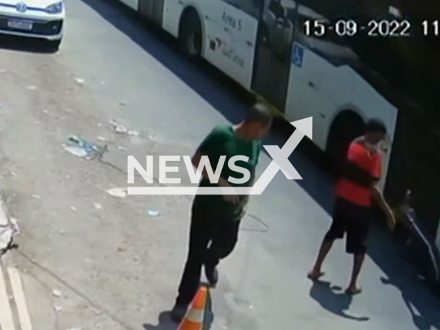 A man pushes his colleague in front of a bus in Ceilandia, Brazil, on Thursday, Sept. 15, 2022.   The bus driver stopped the bus  narrowly avoiding running him over. Note: This picture is a screenshot from the video (Newsflash).