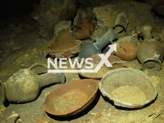 Photo shows the pottery and bronze artefacts inside of a cave in Palmahim National Park, Israel, undated photo. The cave, exposed by a mechanical digger in the course of development works, was accessed for the first time since it was sealed at the time of Rameses II. Note: Licensed photo (Emil Aladjem, Israel Antiquities Authority/Newsflash)