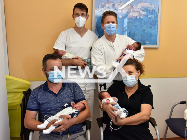 Proud parents Nilgun (front right) and  Kayhan Turan (front left), pose together with their children and Dr Sven Kehltrick (back right) and Dr Patrick Morhart (back left) in undated footage. The couple from the town Pegnitz, Upper Franconia, Bavaria, Germany, became parents after over 10 years of struggling to have children on Sunday, Aug. 18, 2022. Note: Licensed content. (Marie Graber, Uniklinikum Erlangen/Newsflash)