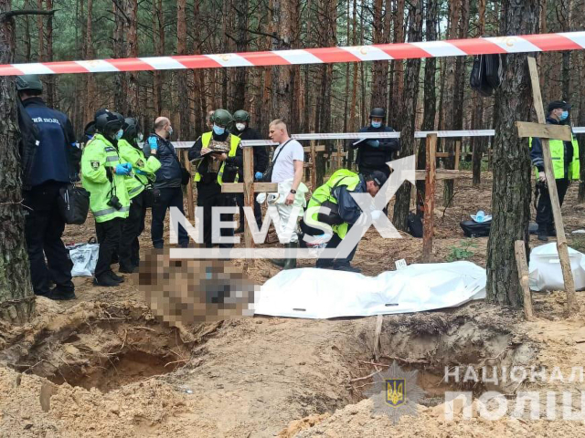 Officers of the National Police of Ukraine of Kharkiv region work at place of mass buries of civil and military people tortured and killed by Russian soldiers in liberated Izyum, Ukraine, Sunday, Sep. 18, 2022. During two days of work officers exhumed 59 bodies. Note: Photo is obtained from the National Police of Ukraine of Kharkiv region (@hk.npu.gov.ua/Newsflash)