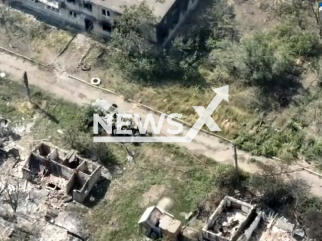 Russian soldiers climb into tank in residential area in the east of Ukraine in undated photo. Russian tank blew up on a minefield while fleeing from the shelling of the 109th Separate Mountain Assault Battalion of the Armed Forces of Ukraine. Note: Picture is a screenshot from a video (@109OGSHB/Newsflash)