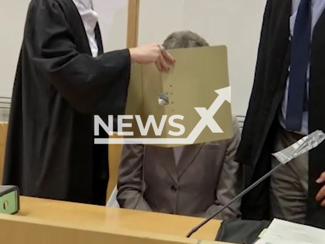 Picture shows the 61-year-old suspect, (middle) in court with lawyers, undated. She is on trial on charges of communal murder  for the death of her son who she put in a sack tied over his  head and placed him in the care of an alleged cult leader, on Aug. 17, 1988, in Hanau, Germany. 
Note: Photo is a screenshot from a video. (Newsflash)