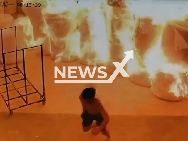 Curious worker ignites a pearl cotton with a lighter causing an uncontrollable fire in an instant in Huizhou, China, Monday, Aug. 22. 2022. He then runs away. Not: Picture is a screenshot from a video (886551317/AsiaWire)