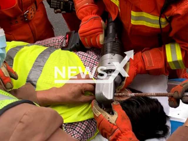 Construction worker receives help after falling from a 30-metre-floor and getting pierced by a steel bar when landing in Luohe, China. The injured was admitted to a hospital for further treatment. Note: Picture is a screenshot from a video (Luohe Fire/AsiaWire)