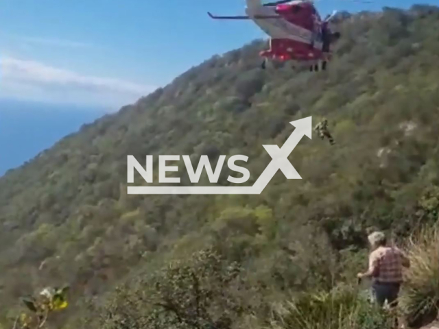 A helicopter from Provincial Fire Brigade Command of Latina rescue an injured hiker on Sept. 20 2022 in San Felice Circeo, Italy. The victim is 63 years old man from Rome, Italy. Note: This picture is a screenshot from the video (Provincial Fire Brigade Command of Latina/Newsflash).