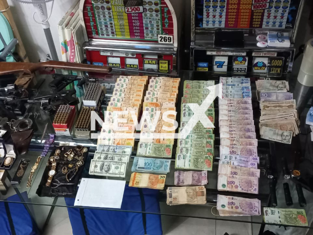 Picture shows money  recovered by police, stolen by   the 49-year-old suspect nicknamed "the cat man", undated. Entering through the roofs in two businesses, in Buenos Aires, Argentina, he stole money and items totalling  ARS 14 million (85.000 GBP).  
 Note: This picture is a screenshot from the video (Policia de la Ciudad/Newsflash).