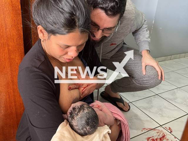 Giselle Soares, 29, breastfeeds her baby after giving birth at her doorstep in Curitiba, Brazil, Monday, Aug. 29, 2022. She was helped by her friend, Dienny Fontelle, 29, who was staying at her house at the time the contractions started. Note: Private photo. (@diennyfontelle/Newsflash)