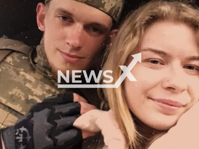 Ukrainian Soldier of the Kharkiv separate territorial defense brigade hugs Yulia, worker of Khariv metro, Ukraine in undated photo. He proposed to Yulia at Kharkiv metro station during Russian attack of Kharkiv. Note: Photo is a screenshot from a video. (@troskhidzsu/Newsflash)