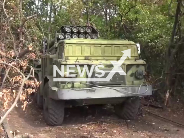 Russian MLRS Hurricane multiple rocket launcher stands among trees in Ukraine in undated photo. Russian artillery units of the Eastern Group of Forces shot at Ukrainian artillery positions, strongholds and accumulations of manpower with the help of MLRS Hurricane. Note: Photo is a screenshot from the video (@mil/Newsflash)