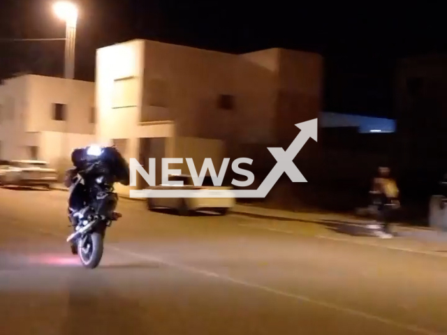 Biker recklessly rides a bike in Conil de la Frontera, Spain, in undated footage. The biker ended up running over a pedestrian on a zebra crossing. Note: This picture is a screenshot from the video. (Policía Local de Conil de la Frontera/Newsflash)