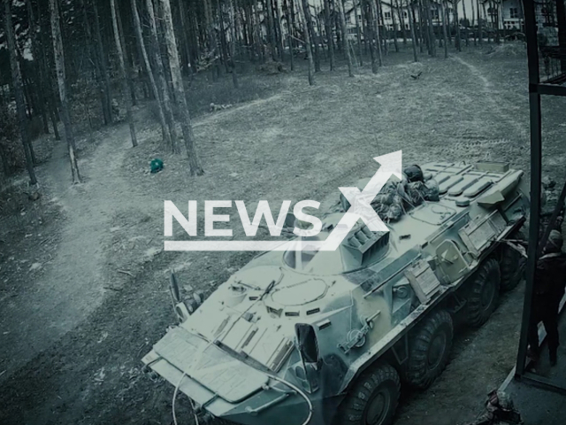 Russian soldiers aim their guns near tank in Hostomel, Ukraine, Friday, Feb. 25, 2022. Russian soldiers shot 12 civil cars with all types of weapons. Note: This picture is a screenshot from the video. (@www.npu.gov.ua/Newsflash)