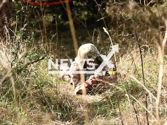 Ukrainian soldier aims a gun in a training area in Great Britain in undated photo. Training of Ukrainian soldiers during INTERFLEX operation was conducted at the facilities of the training and material base of the Armed Forces of Great Britain. Note: This picture is a screenshot from the video. (@GeneralStaffUA/Newsflash)