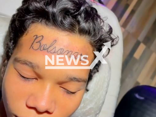 Picture shows the Bolsonaro  tattoo in Baixada Fluminense, Brazil, undated. Joao Carlos Silva, 17, had Brazilian President Jair Bolsonaro's last name tattooed on his forehead. Note: Photo is a screenshot from a video.(@leo_caberna_tattoo/Newsflash)