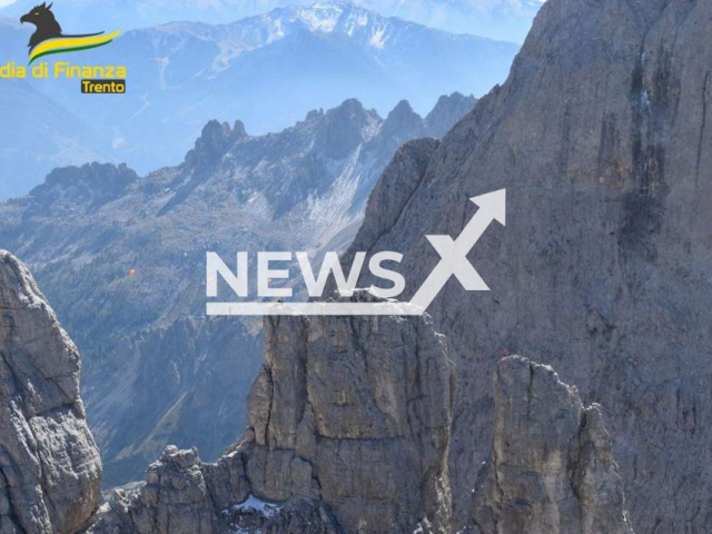 Picture shows   Czech citizens walking on a tightrope, between the Stabeler and Winkler tower of the Dolomites at about 2800 meters elevation, in Italy. They were caught by a police helicopter  and fined for not complying with the provisions on airspace safety. 
Note: Photo from Guardia di Finanza Trento. (Guardia di Finanza Trento/Newsflash)