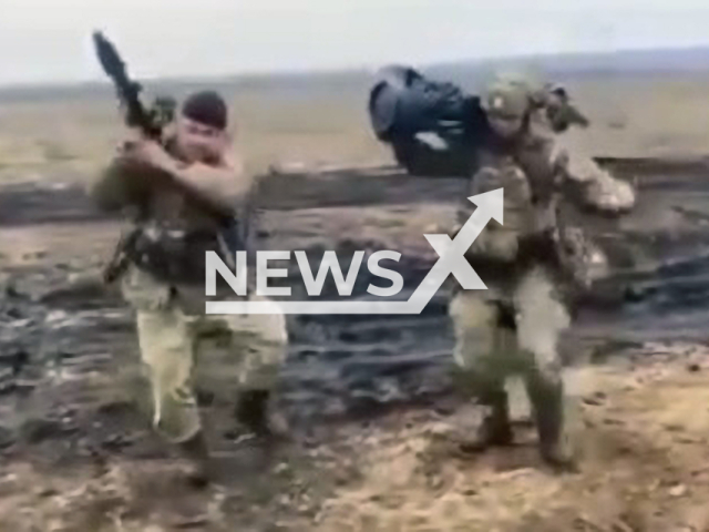 Ukrainian soldiers dance with grenade launchers on hand. Note: Picture is a screenshot from a video (Newsflash)