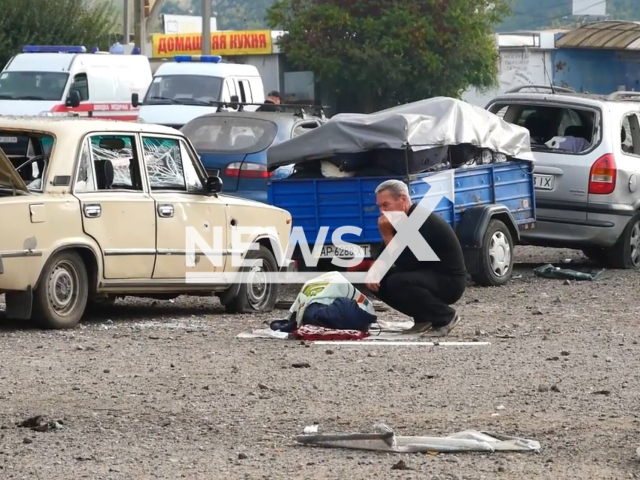 Man cries near died body near damaged cars in Zaporizhzhia, Ukraine, Friday, Sep.30, 2022. As a result of Russian rocket attacks on Zaporizhzhia, 23 people died, another 66 were taken to medical facilities, including 1 child. Note: Photo is a screenshot from a video.(@DSNSZP/Newsflash)