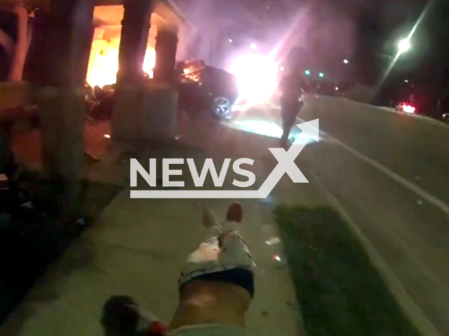 Two Gainesville police officers rescued a man from a burning vehicle at 3800 W. Newberry Road in Gainesville, Florida on the 24th of September. Note: This picture is a screenshot from the video. (Gainesville Police Department/Newsflash)