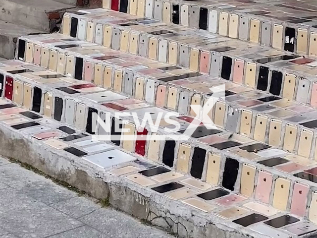 Owner of a mobile phone repair shop has built steps with Apple phone cases in Qingdao, China. Note: This picture is a screenshot from the video (58820657/AsiaWire).