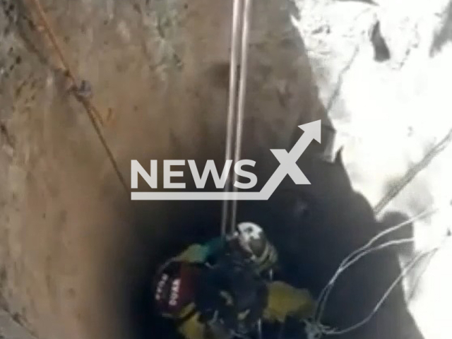 Firefighter goes inside a well at the victims' house looking for remains, in Cordoba, Argentina, undated.
Two brothers, confessed on  Sunday, Oct. 2, 2022,  to having murdered and dismembered Esther Castro, 41,  and Sara Castro, 39, their mother and their aunt in their house.
Note: Photo is a screenshot from a video. (Newsflash)