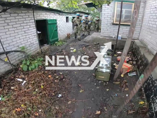 Ukrainian soldiers hold their guns in a residential area of Lyman, Donetsk region, Ukraine in undated photo. Guardsmen of the battalion named after General Kulchytsky conducted stabilization operation. Note: Photo is a screenshot from the video (@NGUmainpage/Newsflash)