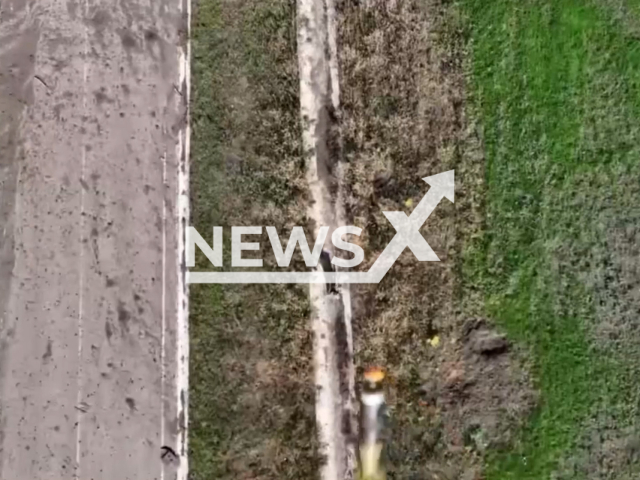 Missile flies from drone to Russian soldier in a field area in Ukraine in undated photo. Fighters of the 10th separate mountain assault brigade detected and destroyed Russian soldier. Note: Photo is screenshot from a video.(@10brygada/Newsflash)