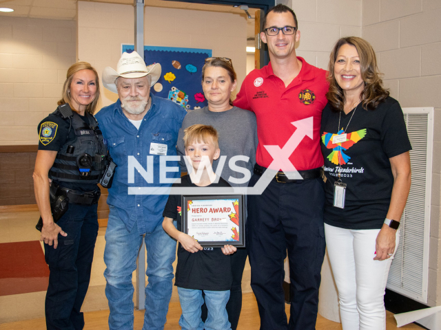 Garrett Brown, 8,  poses with members of police and fire department after receiving a  Hero Award in Norman, Oklahoma, USA, undated. Garrett  saved a friend by  performing the Heimlich manoeuvre when he choked during lunch t school , on Sept. 15, 2022.
 
Note: Firefighters  photo. (@normanokfd/Newsflash