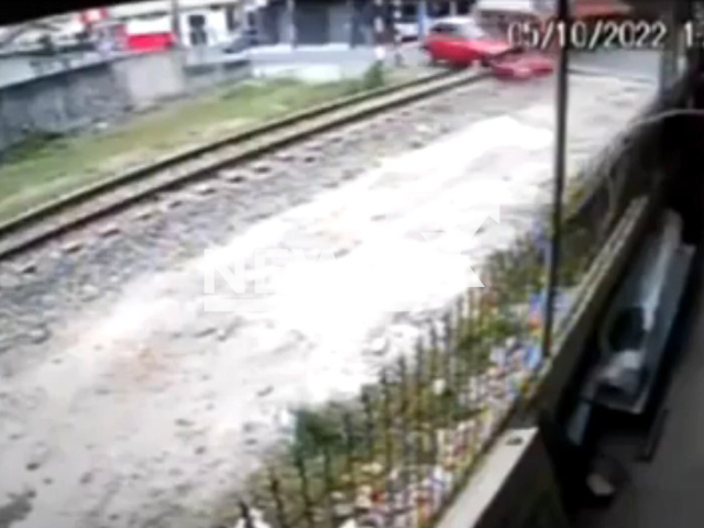 A car is hit a  train  in Criciuma, Brazil, on Wednesday, Oct. 5, 2022.  The driver informed the police that he was distracted by his children. Note: Picture is a screenshot from a video (Newsflash)