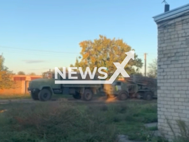 Ukrainian military vehicle pulls Uragan multiple-launch rocket system in a residential area in Kherson region, Ukraine in undated photo. Fighters of the Special Operations Forces of the Armed Forces of Ukraine captured Russian Uragan. Note: Picture is a screenshot from a video. (@usofcom/Newsflash)