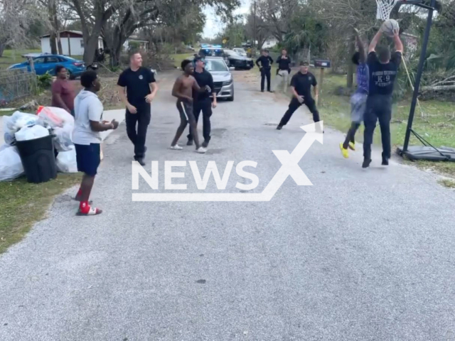 Police officers play basketball with boys in DeSoto County, Florida, the USA in undated video.Note: Photo is a screenshot from a video.(Florida Department of Highway Safety and Motor Vehicles/Newsflash)