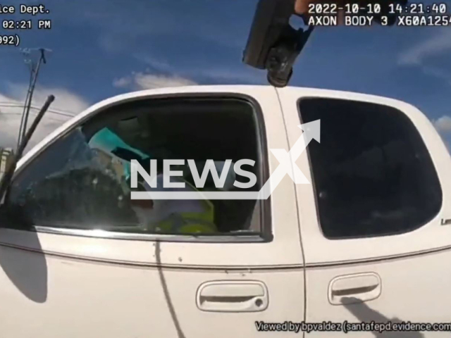 The suspect refuses to stop on a traffic stop and refused commands and accelerated his vehicle in an attempt to flee in Santa Fe, New Mexico, USA on Tuesday, Oct.11, 2022.  Note: Photo is a screenshot from a video.(@santafepolice/Newsflash)