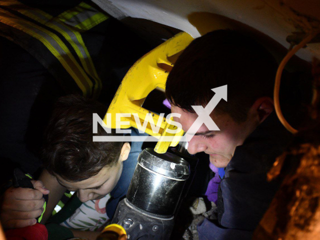 Ukrainian rescuer takes out 12-year-old boy under destroyed building as a result of Russian rocket attacks at night in Mykolaiv, Ukraine, Thursday, Oct. 13, 2022. The boy was under the rubble for more than 6 hours. Note: Picture is obtained from the main department of the State Emergency Service of Ukraine in the Mykolaiv region. (@DSNSMYKOL/Newsflash)