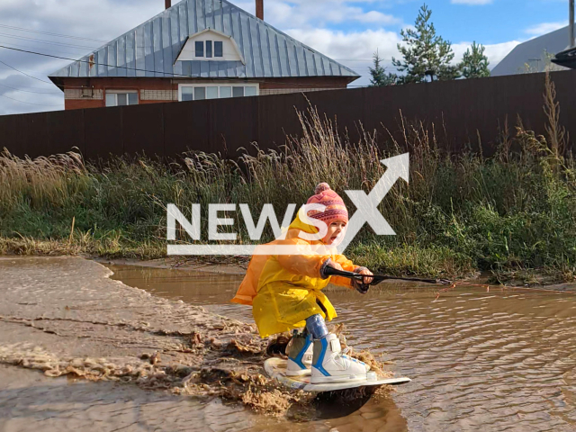 Zara Ivanova, 3, the youngest world champion wakeboard girl rides on puddle in a residential area in Nizhnekamsk, Russia in undated photo. Dmitry Ivanov, girl's dad, is her personal trainer. Note: Picture is a screenshot from a video. (Dmitry Ivanov/Newsflash)