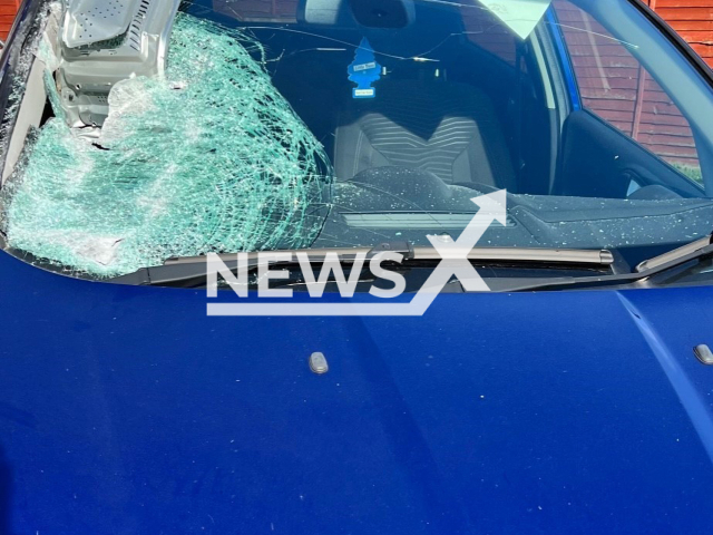 Picture shows the blue Ford Fiesta with a microwave lodged in the windscreen, in Gainsborough, UK, undated.  A passenger on a moped threw the  microwave at the car  on Saturday, Oct. 15, 2022. Note: Police photo. (Lincolnshire Police/Newsflash)