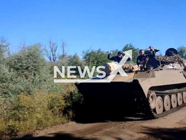 Ukrainian tank moves down the road with Ukrainian soldiers on it in Kherson region, Ukraine in undated photo. Artillerymen of the 36th a separate brigade of marines named after Rear-Admiral Mykhailo Bilynskyi used 122-caliber artillery at the Russian firing position in the Kherson steppes. Note: Picture is a screenshot from a video (@36obmp/Newsflash)