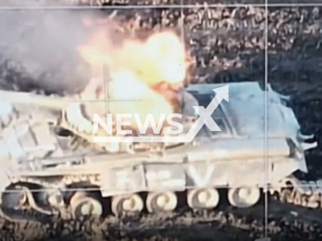 Russian tank with Z and V letters on it burns in a field area in Ukraine in undated photo. Dnipro separate brigade of the Territorial Defense Forces detected and destroyed Russian tank. Note: Photo is a screenshot from the video (Dnipro separate brigade/Newsflash)