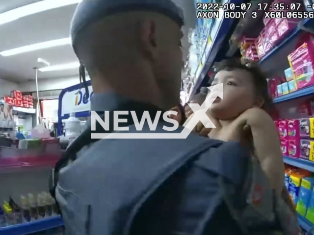 Police officers rescue a little boy who was choked inside a pharmacy. in undated video.Note: Photo is a screenshot from a video.(Military Police of the State of São Paulo/Newsflash)