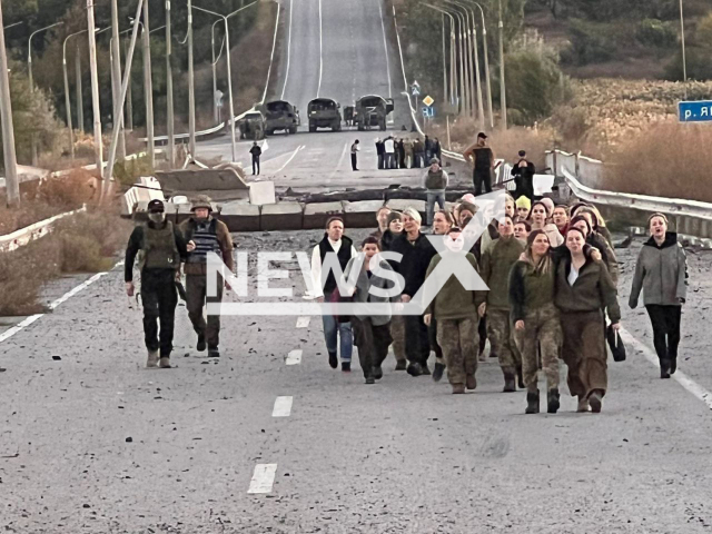 Freed Ukrainian women go down the road during exchange of prisoners of war in Ukraine, Monday, Oct. 17, 2022. As result of the work of the Coordination Staff on the treatment of prisoners of war, 108 military and civilian Ukrainian women were freed from Russian captivity. Note: Picture is obtained from the Coordination Staff on the treatment of prisoners of war. (@Koord_shtab/Newsflash)