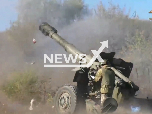 DPR soldier shoots howitzer near the village of Pervomaiske, Donetsk region in Ukraine in undated photo. Soldiers of the 11th regiment and Somali battalion of the People's Militia of the DPR destroyed positions of Ukrainian soldiers. Note: Photo is a screenshot from a video.(@nm_dnr/Newsflash)