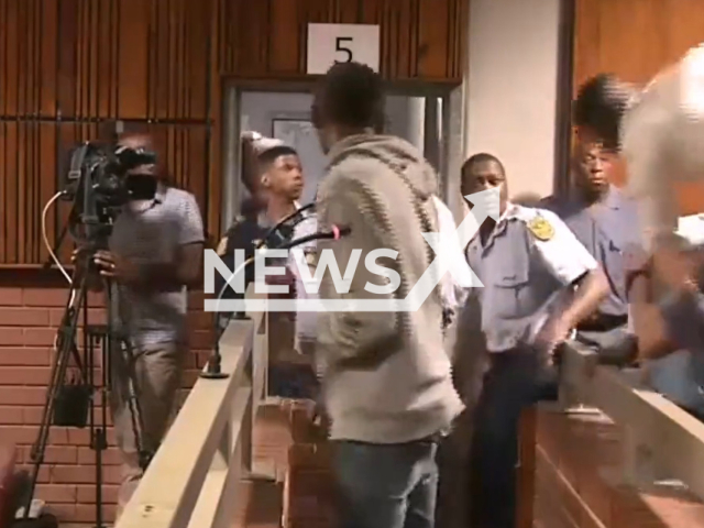 Irvin Ndlovu, the victim's father jumps to attack the man to attack the suspect  Ntokozo Zikhale  in court, in Benoni, South Africa, on Monday, Oct. 17, 2022. He is on trial for the murder of Bokgabo Poo, 4. Note: Photo is a screenshot from a video. (Newsflash)