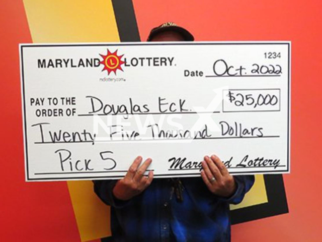 Douglas Eck, 60, poses with check from wining lottery ticked, undated.  He  said he used the numbers from his truck's broken odometer. Note: Licensed photo.  (Maryland Lottery/Newsflash)