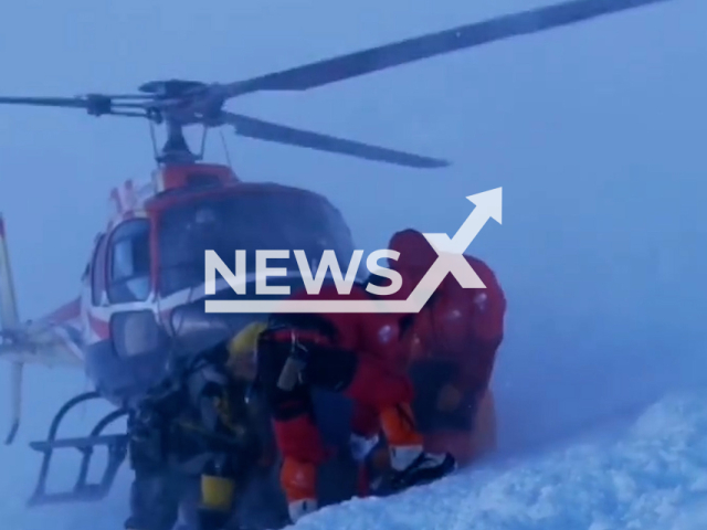 Helicopter descends in order to evacuate victims despite bad weather conditions after an avalanche near camp 3 at the elevation of 6,888m of Manaslu, in Nepal, on Monday, Sept. 26, 2022. Many people were injured and there was one casualty. Note: Photo is screenshot from a video (@pasang_rinzee/Newsflash)