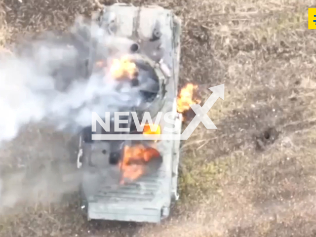 Russian tank burns in a field area in Donetsk region, Ukraine in undated photo. Soldiers of 13th Main Directorate of the Military Counterintelligence Department of the Security Service of Ukraine dropped bomb into the hatch of Russian infantry fighting vehicle from drone. Note: Picture is a screenshot from a video (@SBUkr/Newsflash)