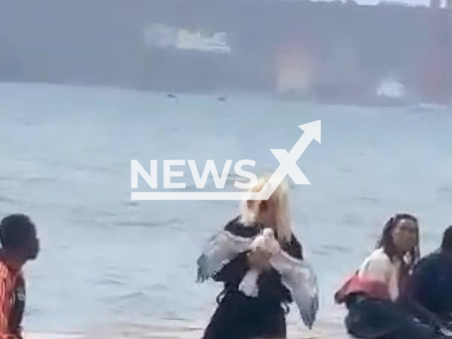 A Dutch woman dances with a seagull in her hands  in Lisbon, Portugal, on Saturday, Oct. 22, 2022. She was was arrested for  trying to wring its neck and taken to a psychiatric hospital. 
 Note: Picture is a screenshot from a video (Newsflash)