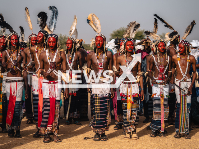 Young men in elaborate ornamentation and traditional face painting pose and sing during the Guerewol ritual in Niger, undated. The Guerewol is an annual courtship ritual competition among Niger’s Wodaabe Fula people. Note: We obtained permission for this photo. (Kristijan Ilicic/Newsflash)