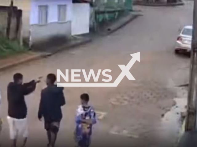 A man points a gun at  an unidentified 16-year-old  in Simonesia, Brazil, on Monday, Oct. 24, 2022. He was walking by and was surprised by two people he did not know, and shot 11 times,  they have not been arrested. Note: Photo is a screenshot from the video (Newsflash)