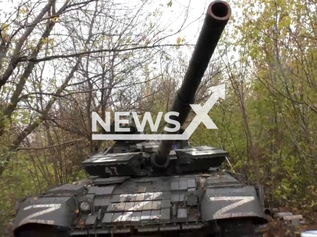 DPR tank with Z letters on it stands among trees in Avdiivka direction, Ukraine in undated photo. Soldiers of 1st Slavic brigade of the People's Militia of the DPR shot at Ukrainian positions from tank. Note: Picture is a screenshot from a video (@nm_dnr/Newsflash)