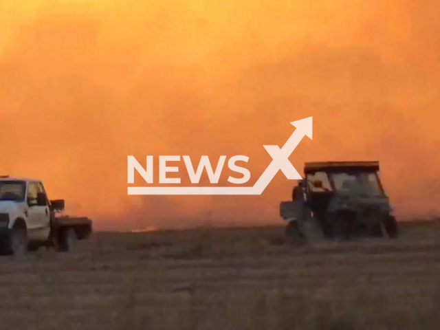 Picture shows two vehicles in front of a fire in Arkansas, US, on Sunday, Oct. 23, 2022. According to storm chaser, Robert Brock, 54, the rice field burns got out of control from the high winds. Note: Picture is screenshot from a video(Robert Brock/Newsflash)